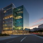 A modern, multi-story building with large glass windows and the Autodesk logo, set against a sunny San Francisco skyline.