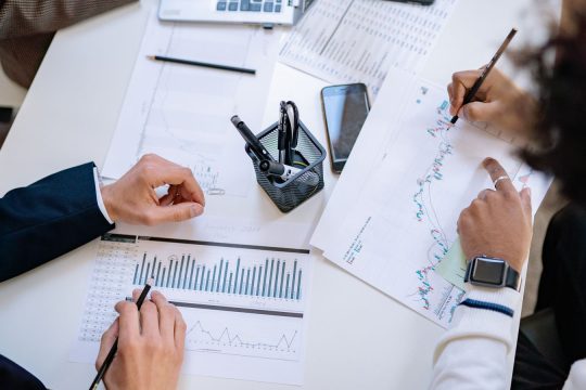 Business planning charts reviewed at a meeting
