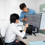 Engineers reviewing code on a monitor: Test a Public-Record API Thoroughly Before You Build On It