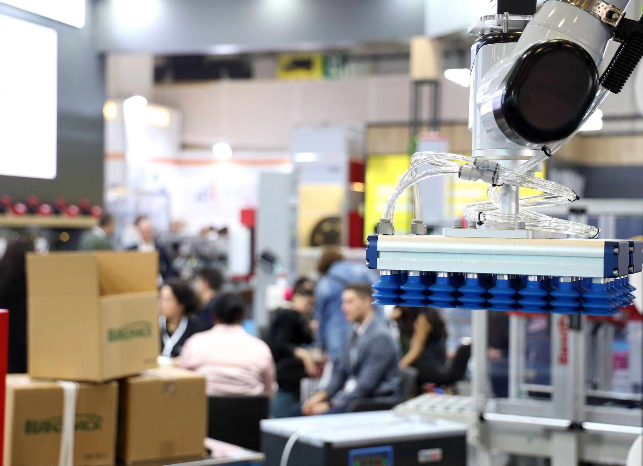 Four days in October 2026 will unite the packaging world in Istanbul: a robotic vacuum gripper lifting cartons on an exhibitor stand at Eurasia Packaging Istanbul