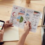 How to Judge Whether an Agency Truly Understands Your Industry: marketing specialists reviewing SEO and campaign analytics charts at a desk